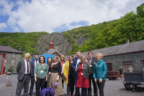 Members of the committee standing together at the site for a photo