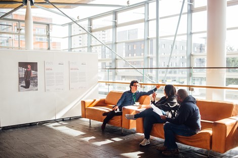 People sitting on sofas in the Oriel of the Senedd